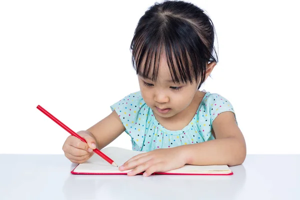 Asiático menina chinesa escrevendo no caderno de exercícios Fotografia De Stock