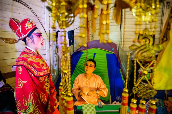 Çin Opera grubu üyesi, sahne arkasında hazırlar