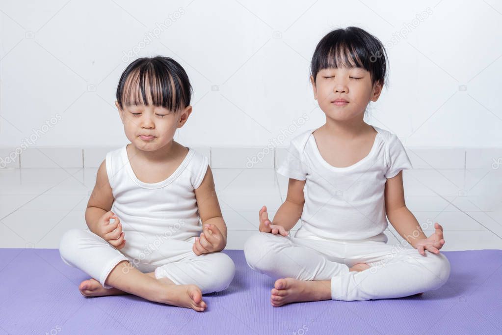 Asian Chinese little girls practicing yoga pose