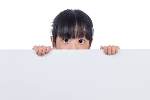 Asian Chinese little girl peeping behind white board