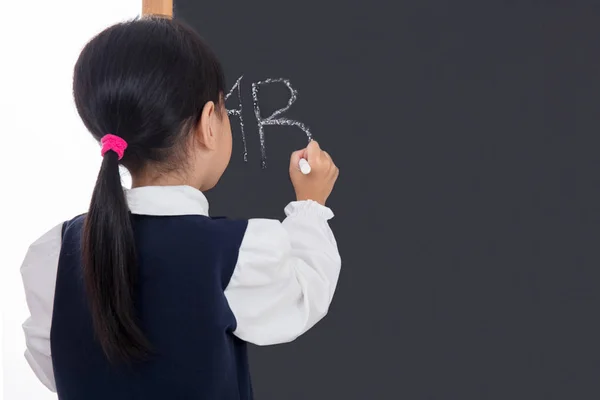 Asian Chinese little girl writing on blackboard — Stock Photo, Image