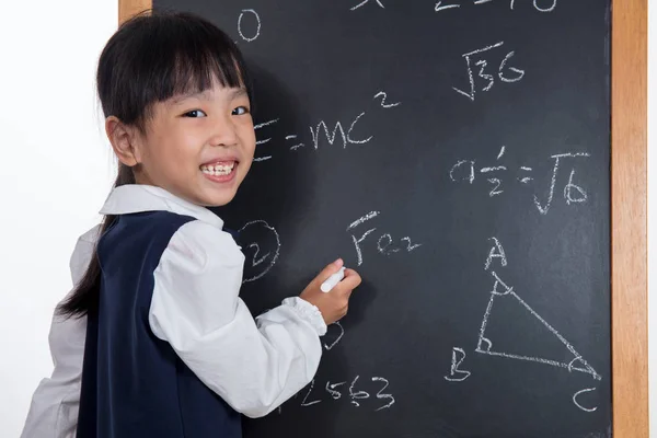 Asian Chinese little girl writing on blackboard — Stock Photo, Image