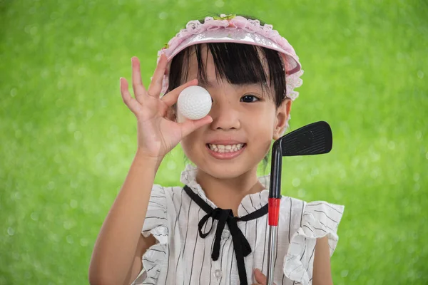 Asian Chinese little girl holding a golf ball — Stock Photo, Image
