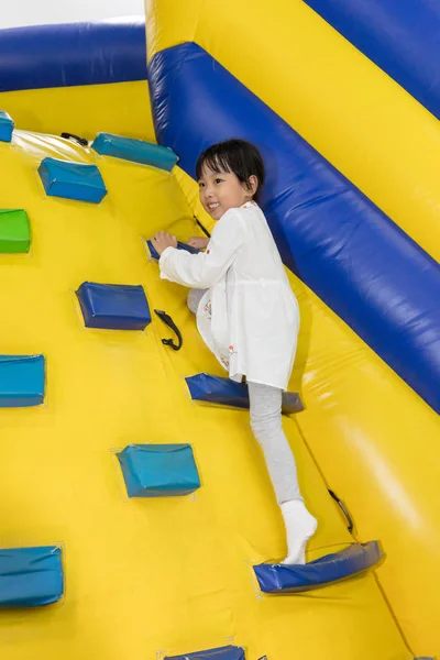 Asian Little Chinese Girl climbing up ramp — Stock Photo, Image