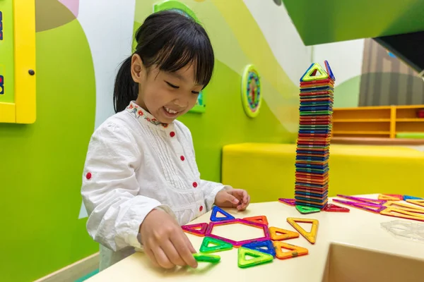 Asiática china niña jugando colorido imán plástico bloques — Foto de Stock