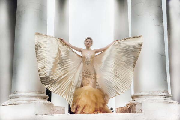 model girl in dress gold angel