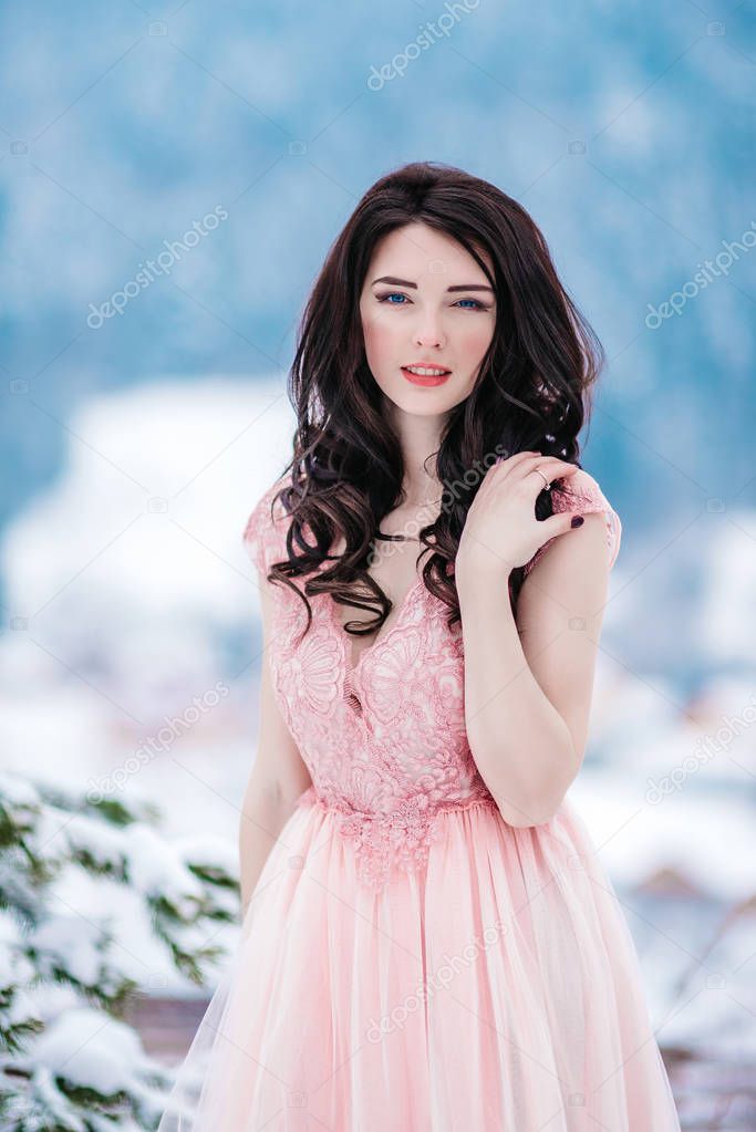 bride with chestnut hair, blue background of the winter mountain