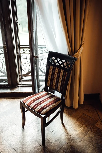 Old vintage chair on oak flooring Stock Photo