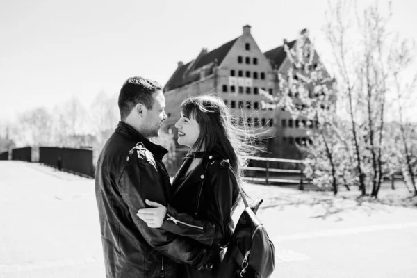 happy guy and girl walking along the tourist streets of old Europe in the city of Gdansk