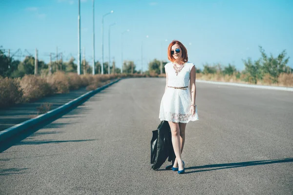 Menina Ruiva Uma Jaqueta Preta Óculos Azuis Uma Estrada Cinza — Fotografia de Stock