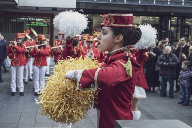 Belgrade, Serbia, Feb 22, 2017: Majorettes and musicians from Herceg Novi (Montenegro) take part in a parade at K. Mihailova Street in honor of the feast that celebrates the flowing of mimosa on the Adriatic coast which marks the end of winter season clipart