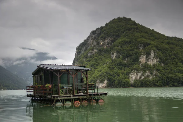 TARA National park, Western Serbia - A raft log cabin anchored on the Lake Perucac
