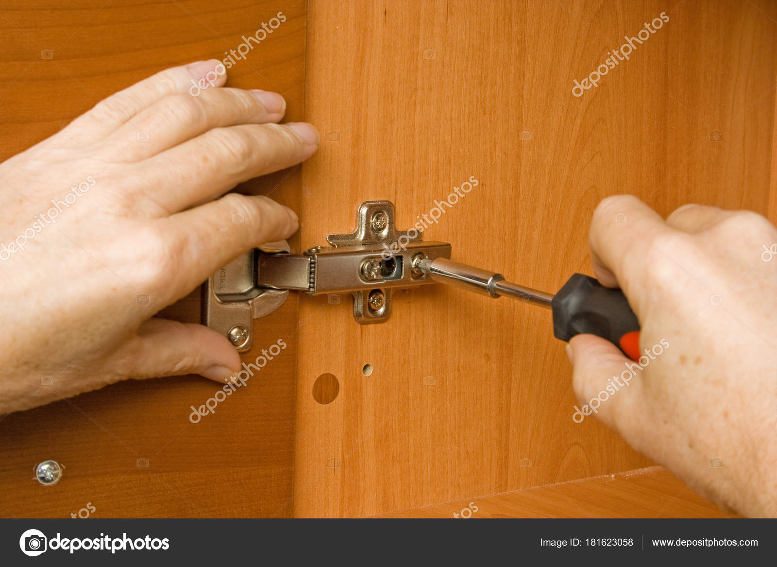Carpenter Adjusting A Cabinet Door Hinge Stock Photo C Hansgeel
