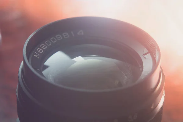 Camera lens with reflections. Shot in studio.