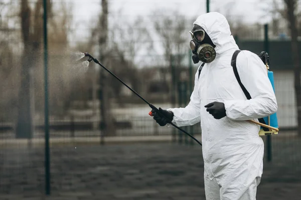 Cleaning and Disinfection at town complex amid the coronavirus epidemic Professional teams for disinfection efforts Infection prevention and control of epidemic Protective suit and mask.