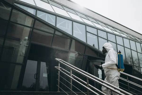 Cleaning and Disinfection at town complex amid the coronavirus epidemic Professional teams for disinfection efforts Infection prevention and control of epidemic Protective suit and mask.