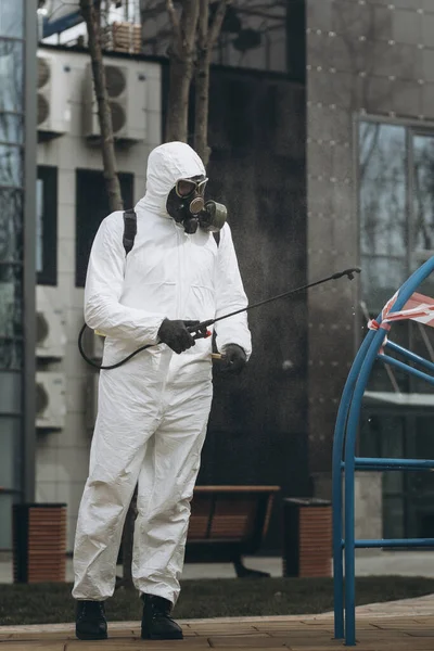 Cleaning and Disinfection on the playground in the sity complex amid the coronavirus epidemic Professional teams for disinfection efforts Infection prevention and control of epidemic Protective suit and mask and spray bag,