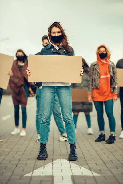 A group of people with mask who came out with posters to protest The protest of the population against coronavirus and against the introduction of quarantine Meeting about coronavirus and people rights. Copyspace