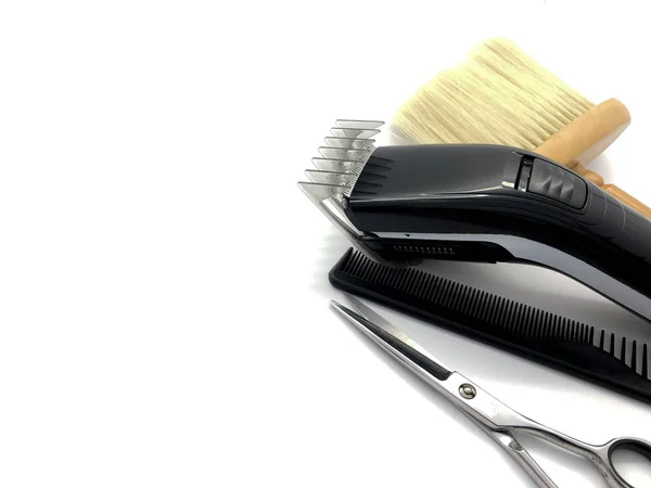 Hairdressing tools isolated on a white background. Male tool kit. Professional tools for a beauty salon. Composition of combs, scissors, clippers and brushes