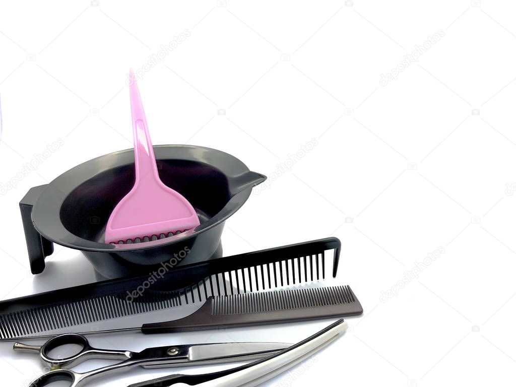 Bowl for paint, comb, pink brush and scissors isolated on a white background. Set of professional hairdressing tools for hair coloring. Composition of tools for a beauty salon.