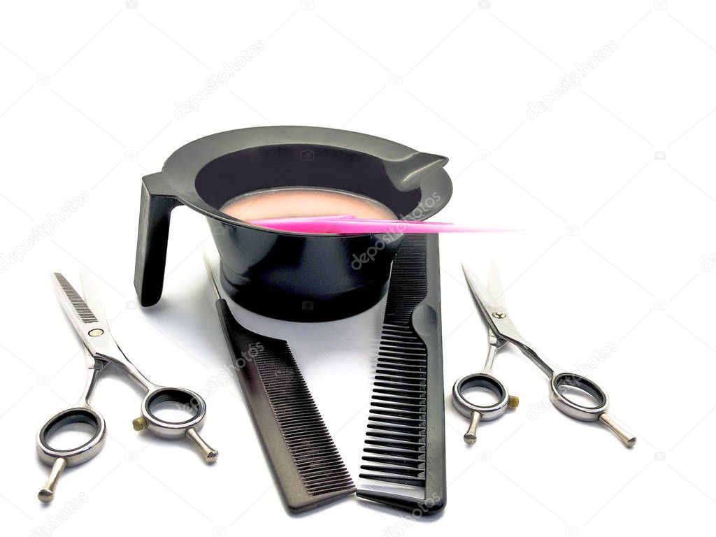 Bowl for paint, comb, pink brush and scissors isolated on a white background. Set of professional hairdressing tools for hair coloring. Composition of tools for a beauty salon.