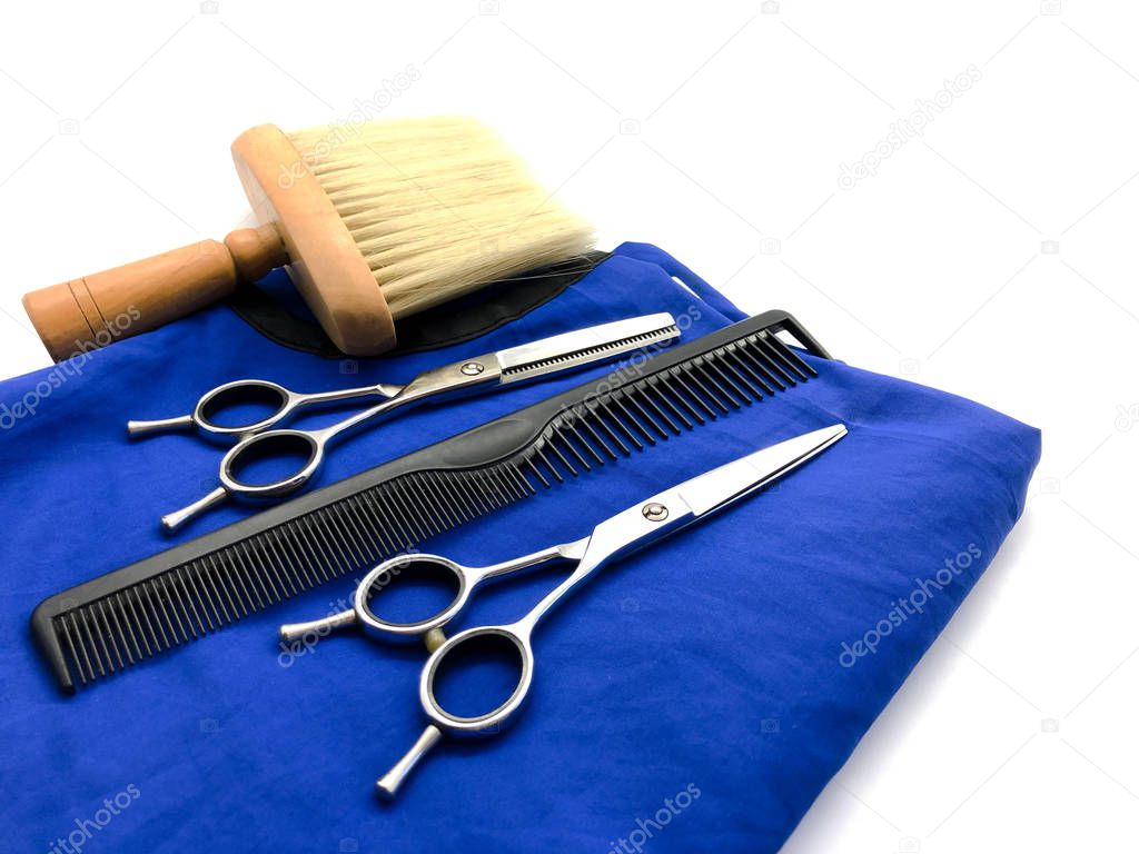 Hairdressing scissors, thinning scissors, comb, brush and hairdresser cape isolated on white background. Composition of hairdressing tools for a beauty salon. Set for cutting hair.