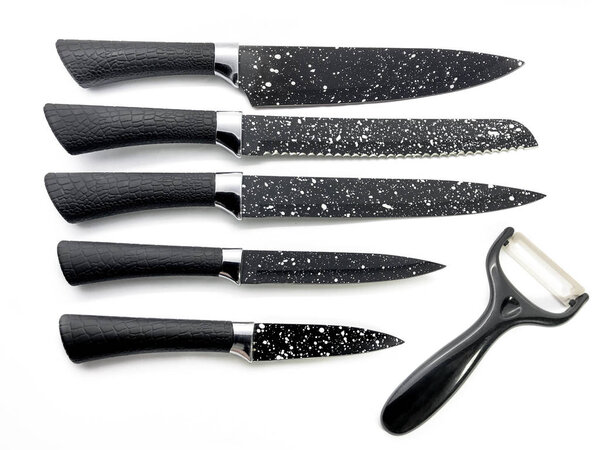 Set of professional black knives and peeler isolated on a white background. Composition of the chef knife, bread knife, utility knife, paring knife and ceramic peeler.