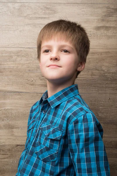 Smiling boy against a wall Stock Image