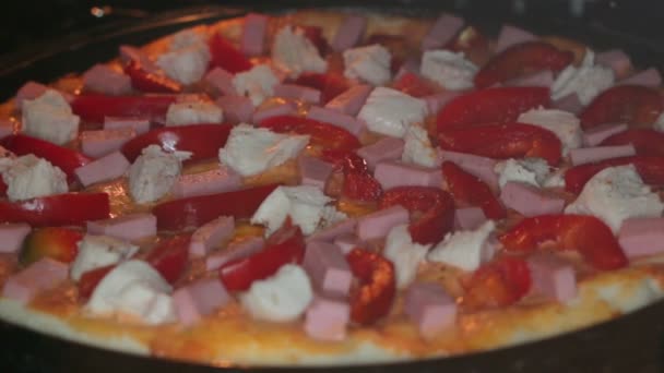 Putting pizza in oven at restaurant kitchen — Stock Video