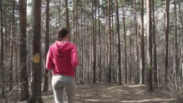Athletic young woman running in the nature. — Stock Video