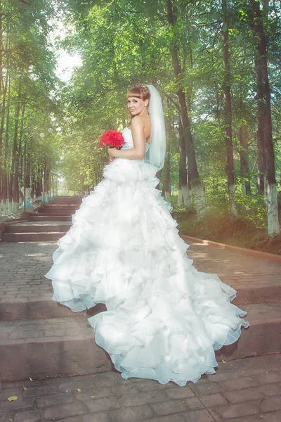Young bride with red bouquet