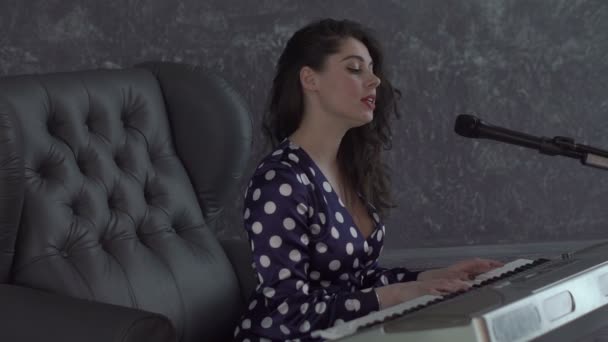 Dívka zpívat do mikrofonu a hrát na klávesnici — Stock video