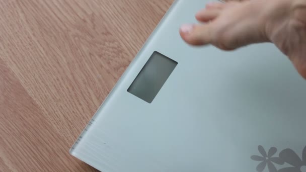 Obese woman getting on scales for weight control during healthy diet — Stock Video
