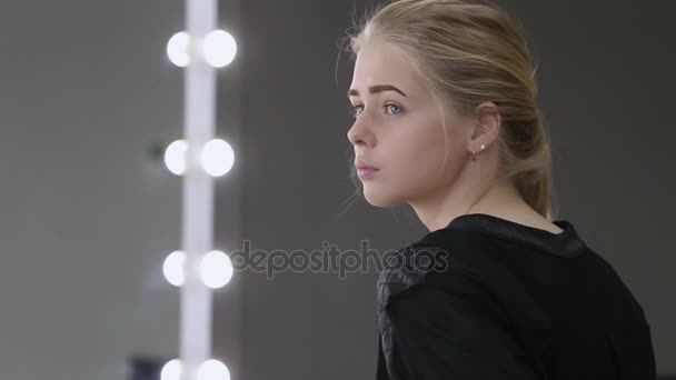 Young woman sitting in a waiting room — Stock Video