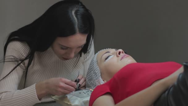 Eyelash Extension Procedure. Woman Eye with Long Eyelashes. — Stock Video