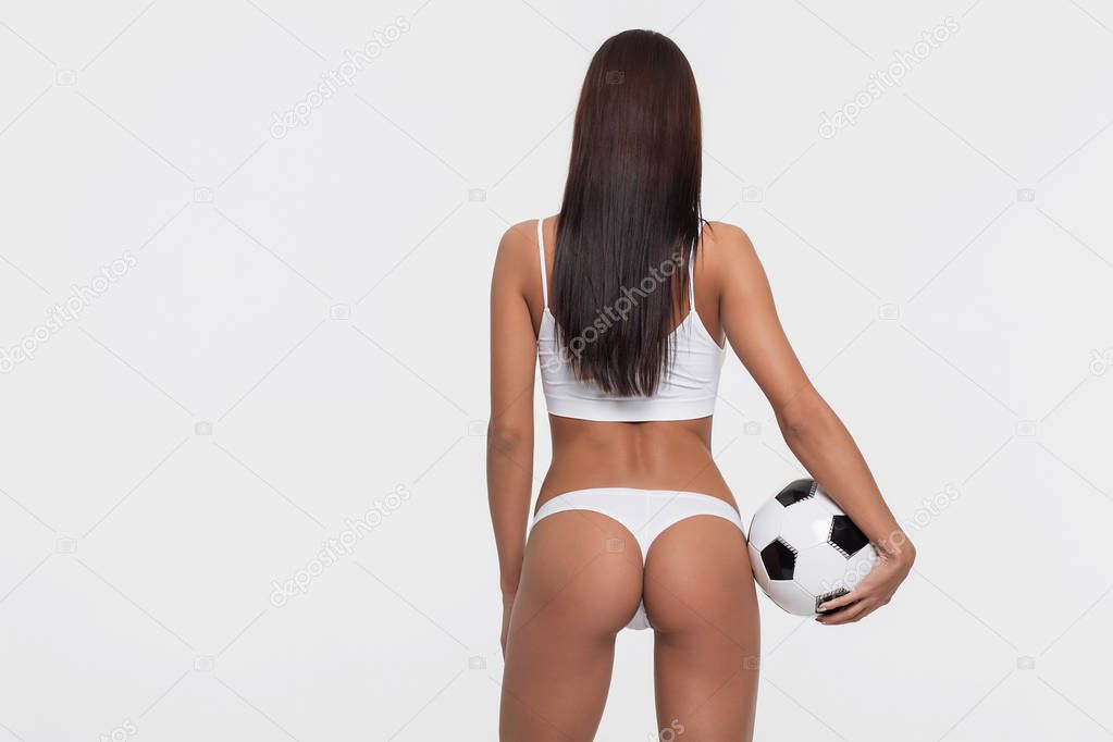 Sexy brunette with a soccer ball