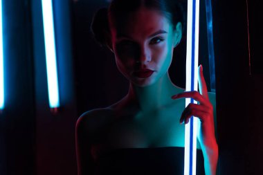 Neon lambalı zayıf kadın.