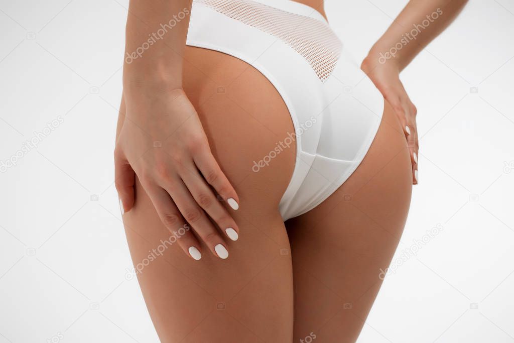 Faceless sexy woman with hands on ass