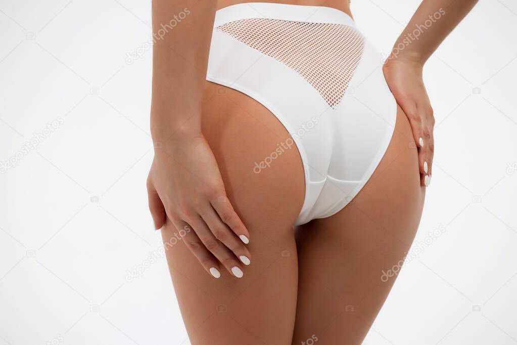 Faceless sexy woman with hands on ass