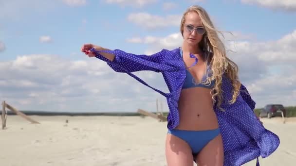 Mladá žena, zvedící ruku a obracejí se ve světle stylové plavky — Stock video