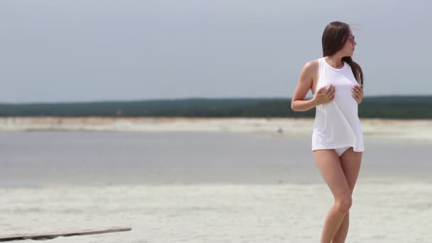 Hete vrouw innemend wandelen op tiptoe in zand — Stockvideo