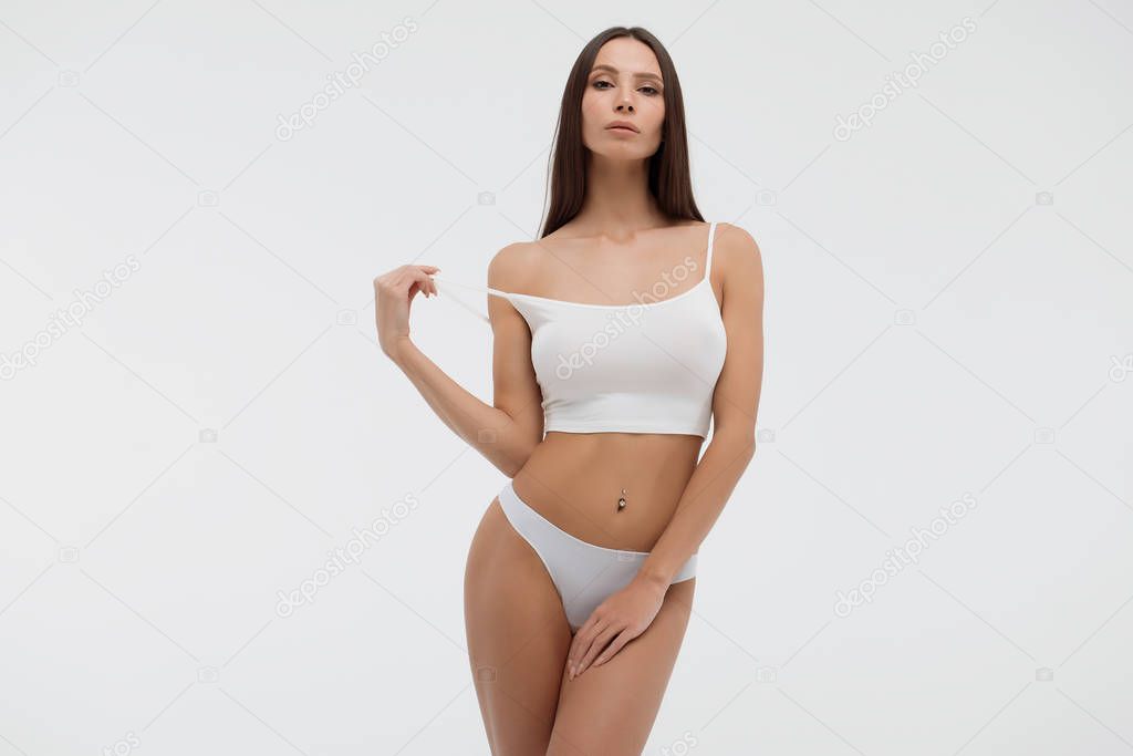 Sensual woman in underwear looking at camera alluringly