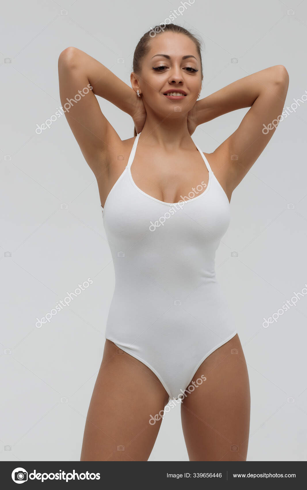 Crop gorgeous woman taking off swimsuit - Stock Photo, Image. 