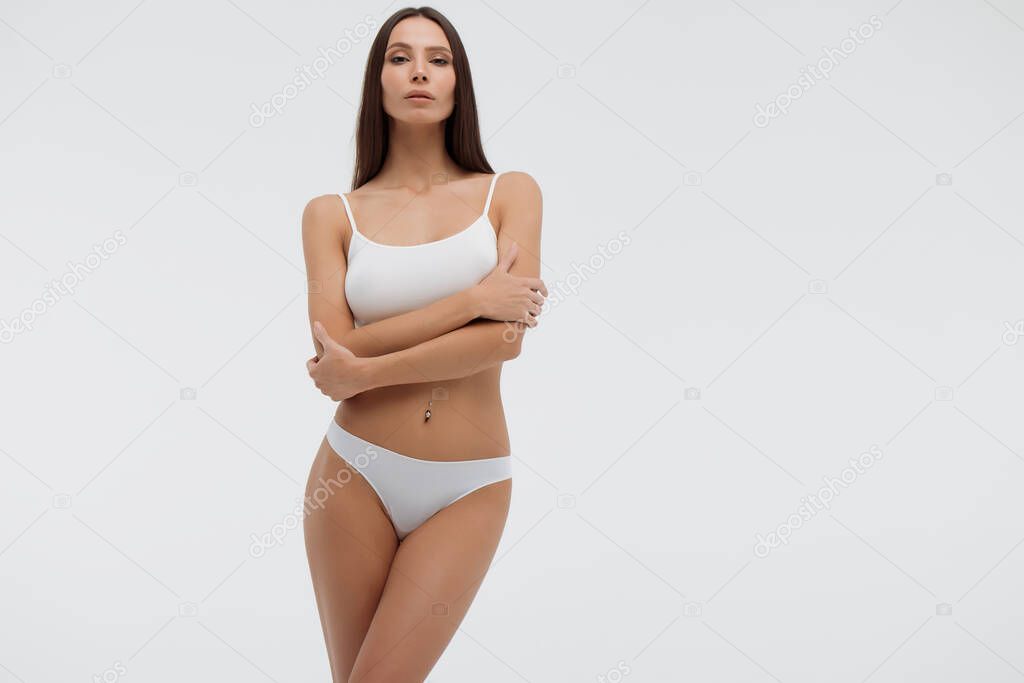 Sensual woman in underwear looking at camera alluringly