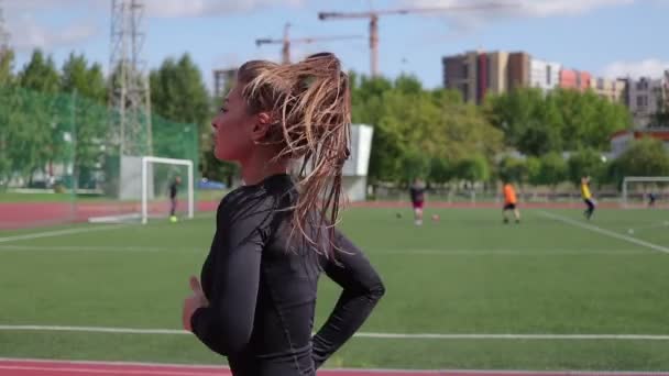 Стройная женщина бегает по городскому стадиону — стоковое видео