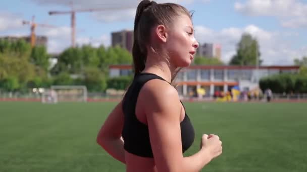 Slanke vrouw die in het stadion van de stad loopt — Stockvideo