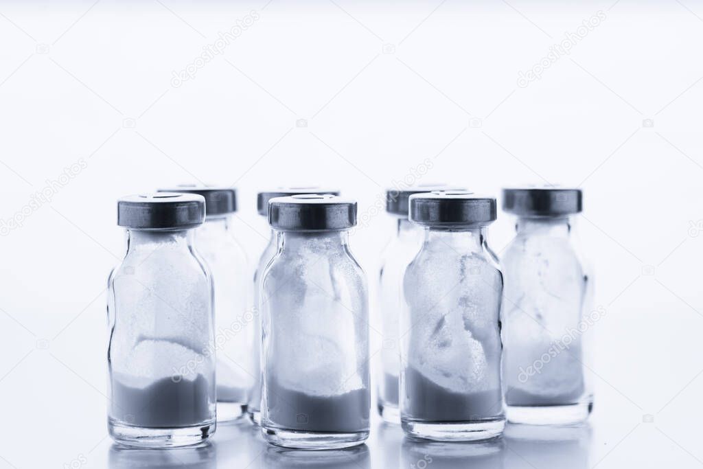 Antibiotic. A row of glass medical vaccine bottles