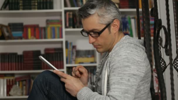 Relaxed Man Eyeglasses Holding Digital Tablet Talking Mobile Phone Blurry — kuvapankkivideo