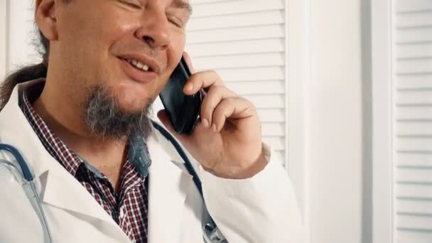Male Physician Having Break Talking Mobile Phone — Stock Video