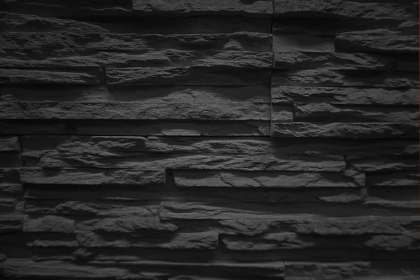 Grunge dark grey or black stone wall texture